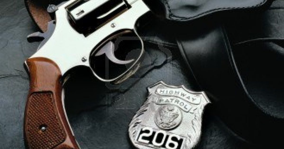 3959950-police-gun-with-holster-and-badge-on-dark-background
